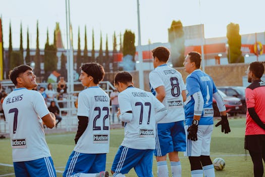 youth soccer players celebrating a goal together